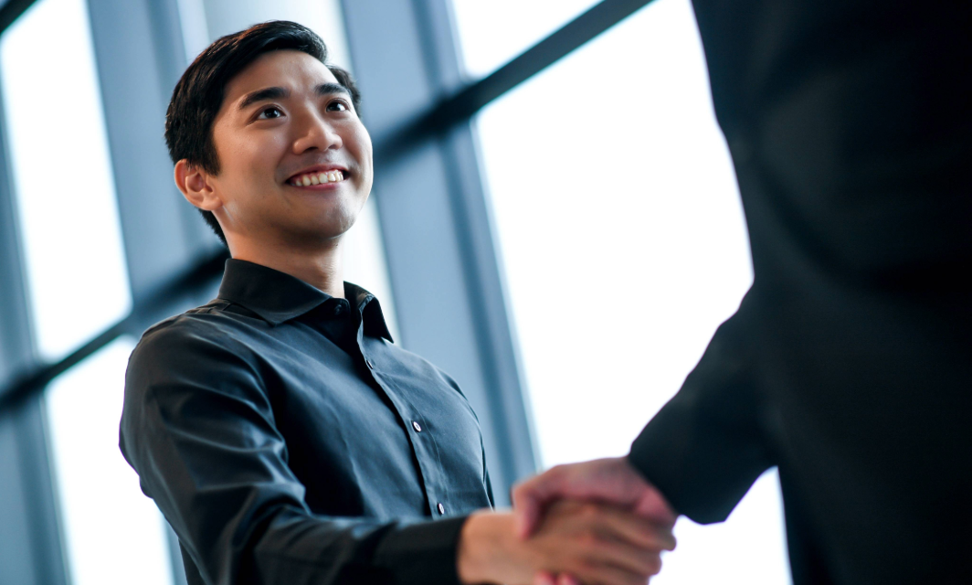 Student shaking hands with industry professional