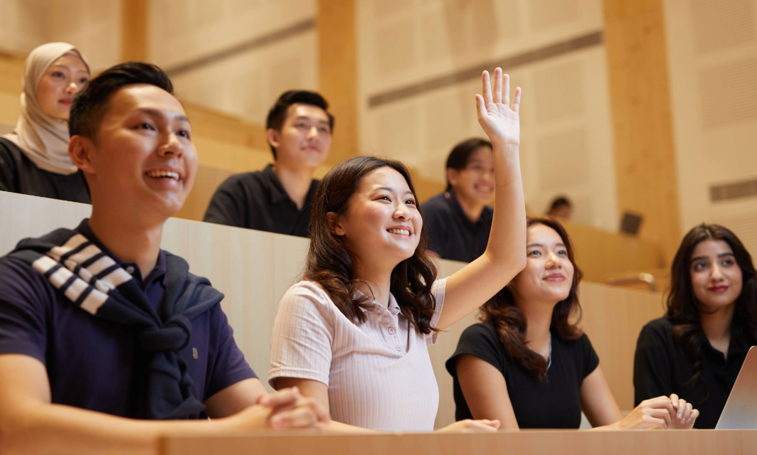 Student raising up her hand in class