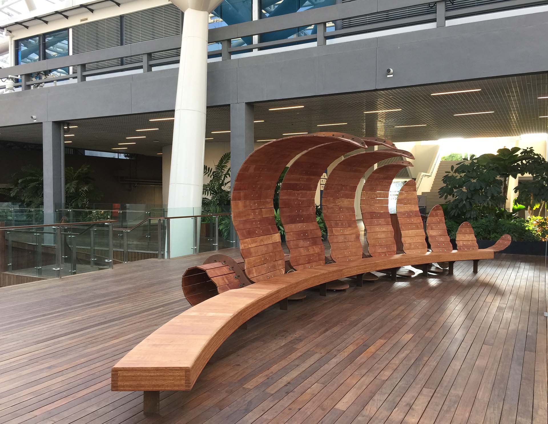 Fern, an art installation that doubles as a wooden bench shaped like the frond of a fern