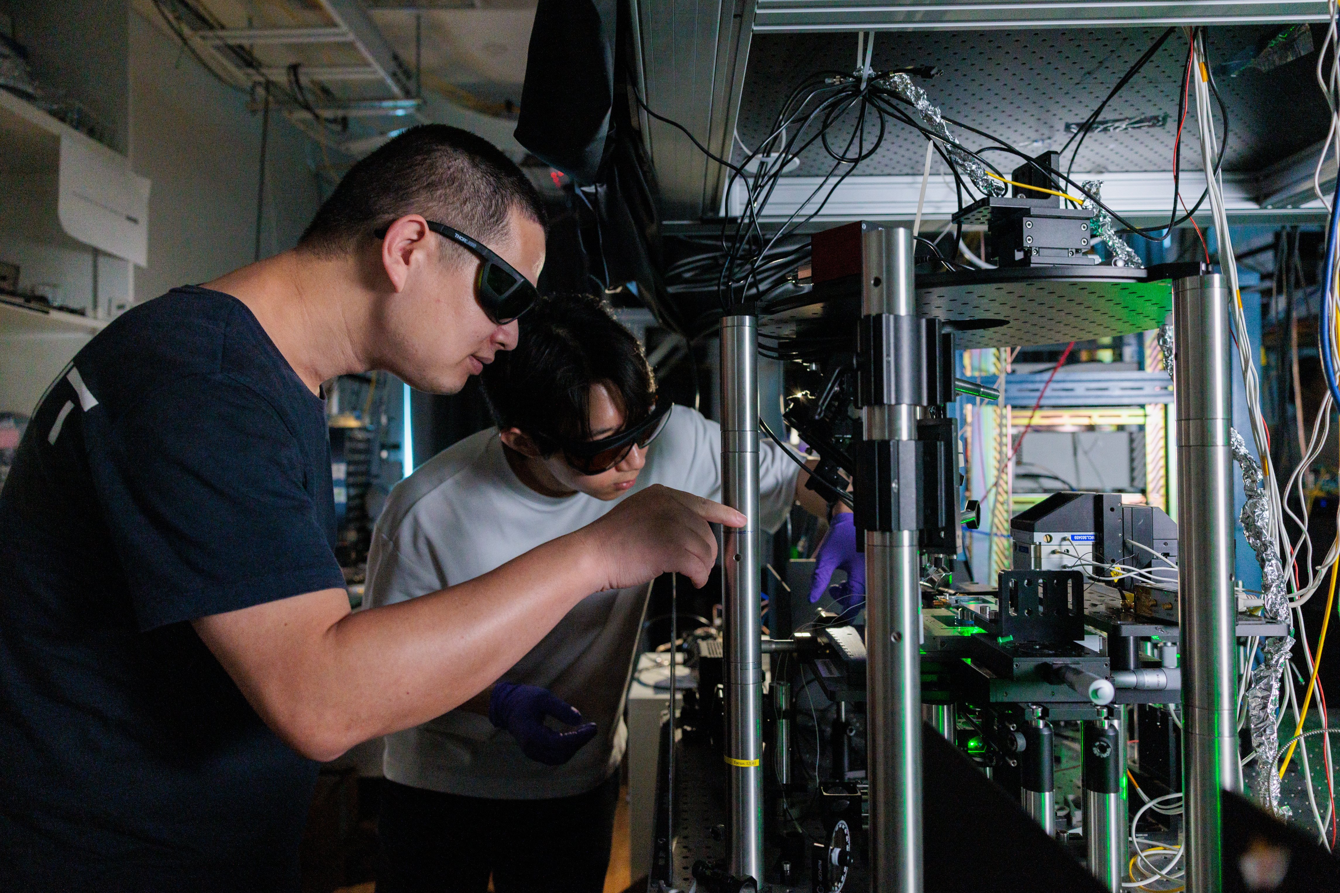 Photo of Dr Cai Hongbing, with the team's experimental setup