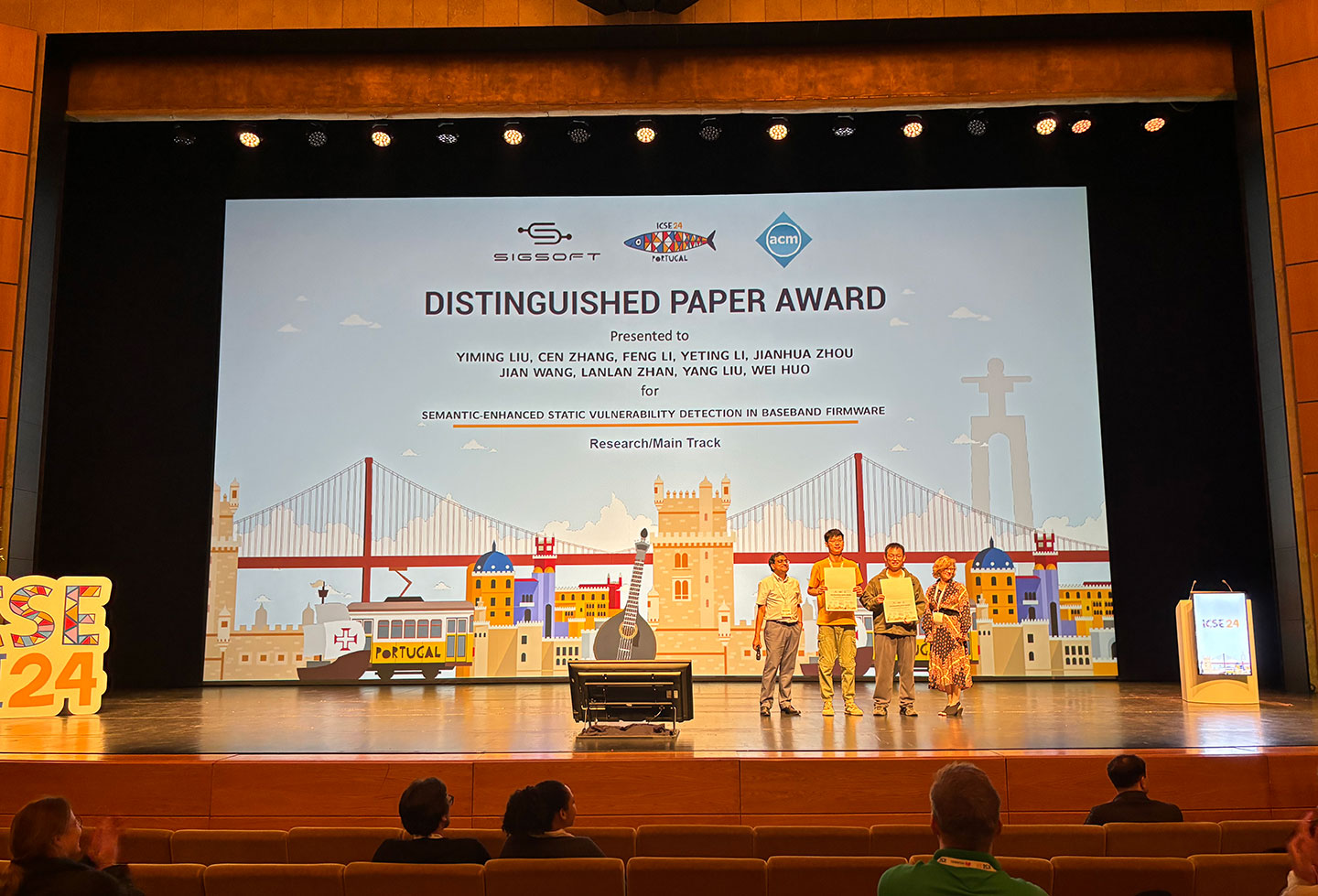 Photo of ACM SIGSOFT Distinguished Paper Award presentation on stage.