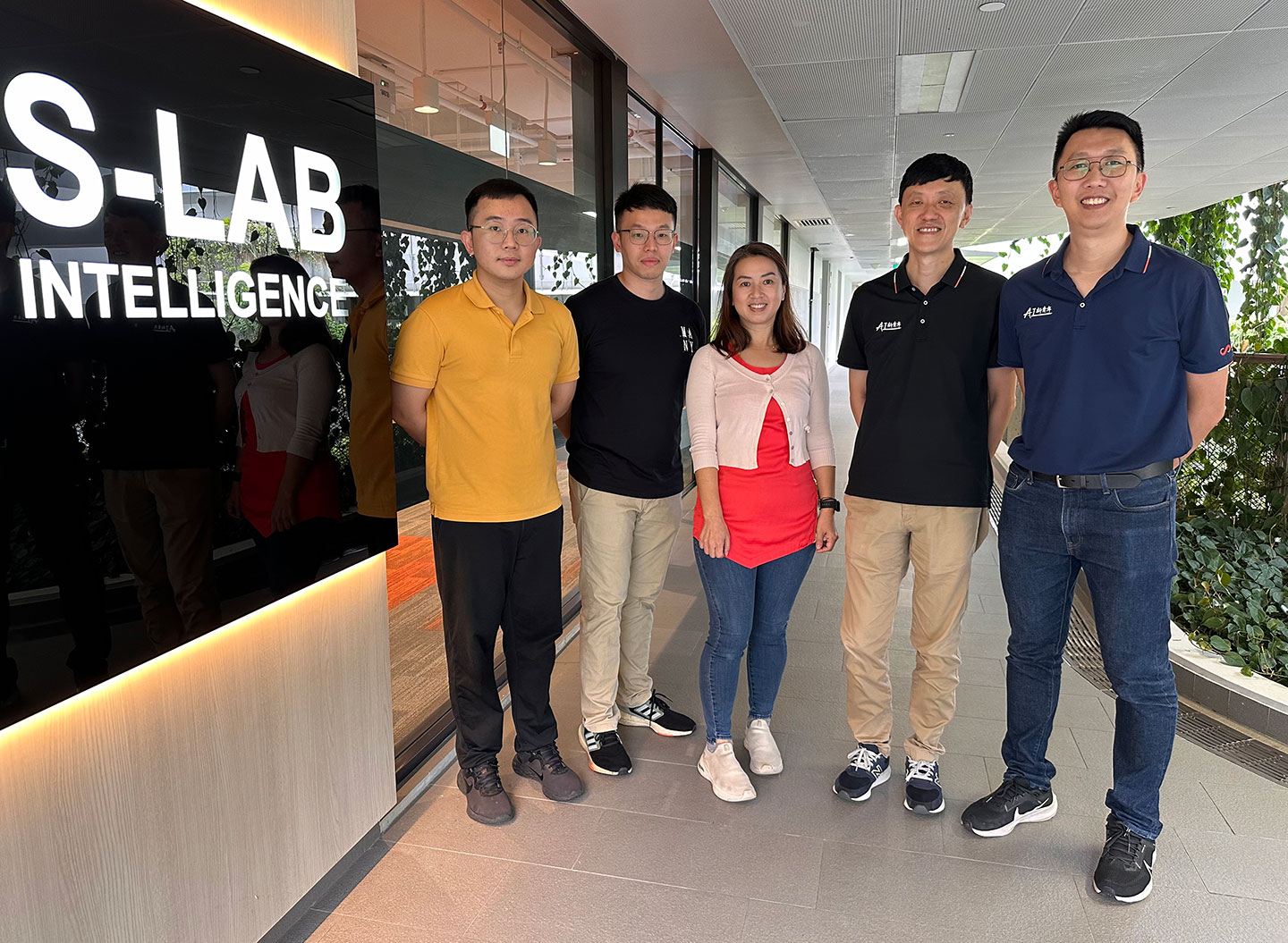 Photo of a group of researchers at the entrance of S-lab.