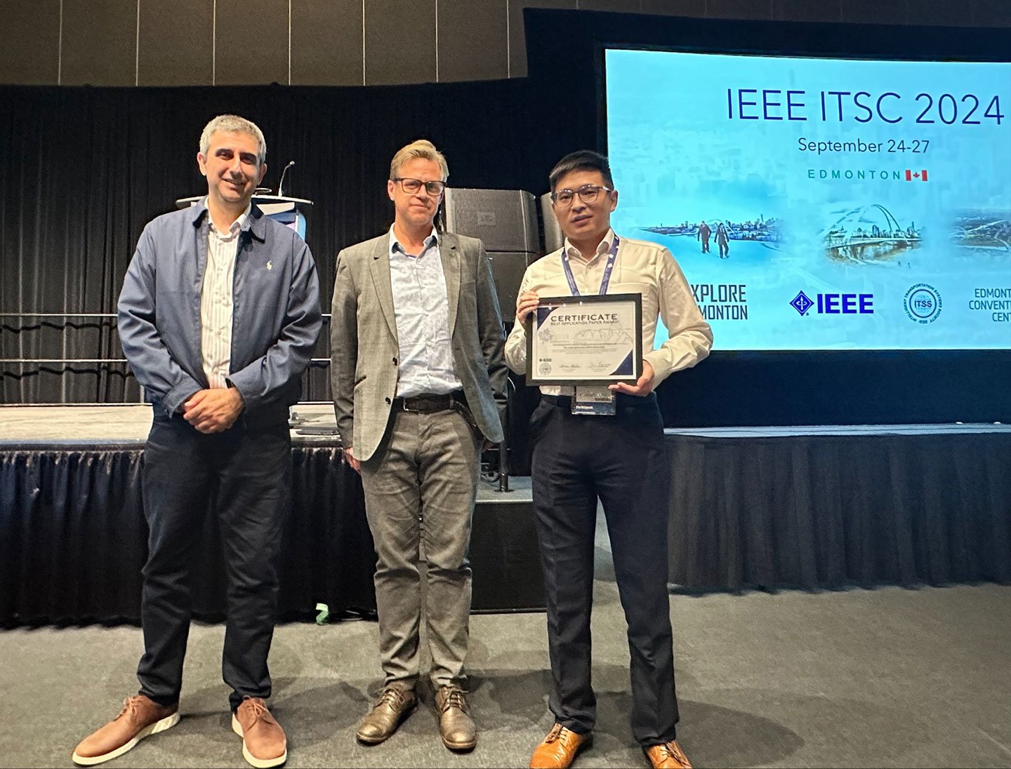 Photo shown a researcher received the Best Application Paper on behalf of his team at the IEEE ITSC 2024 award presentation ceremony.