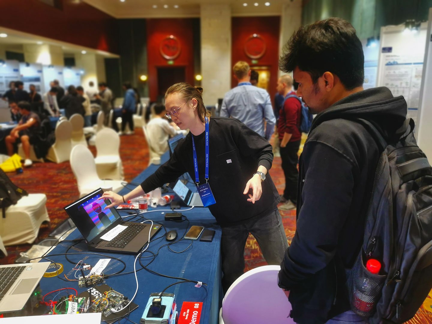 Photo of a researcher demonstrating the system to the audience.