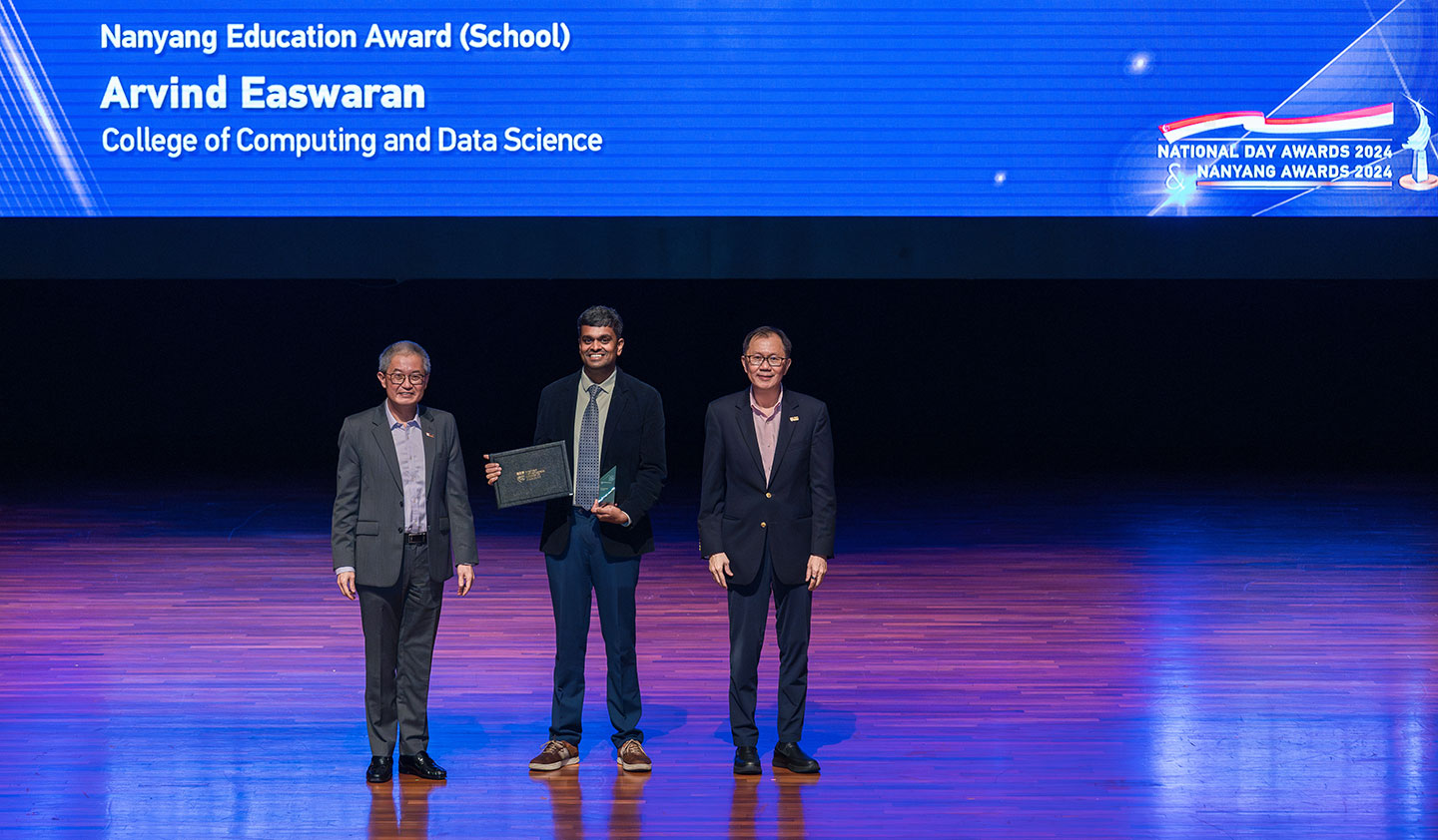 Photo of Prof Arvind Easwaran receiving the Nanyang Education Award (School) on stage.