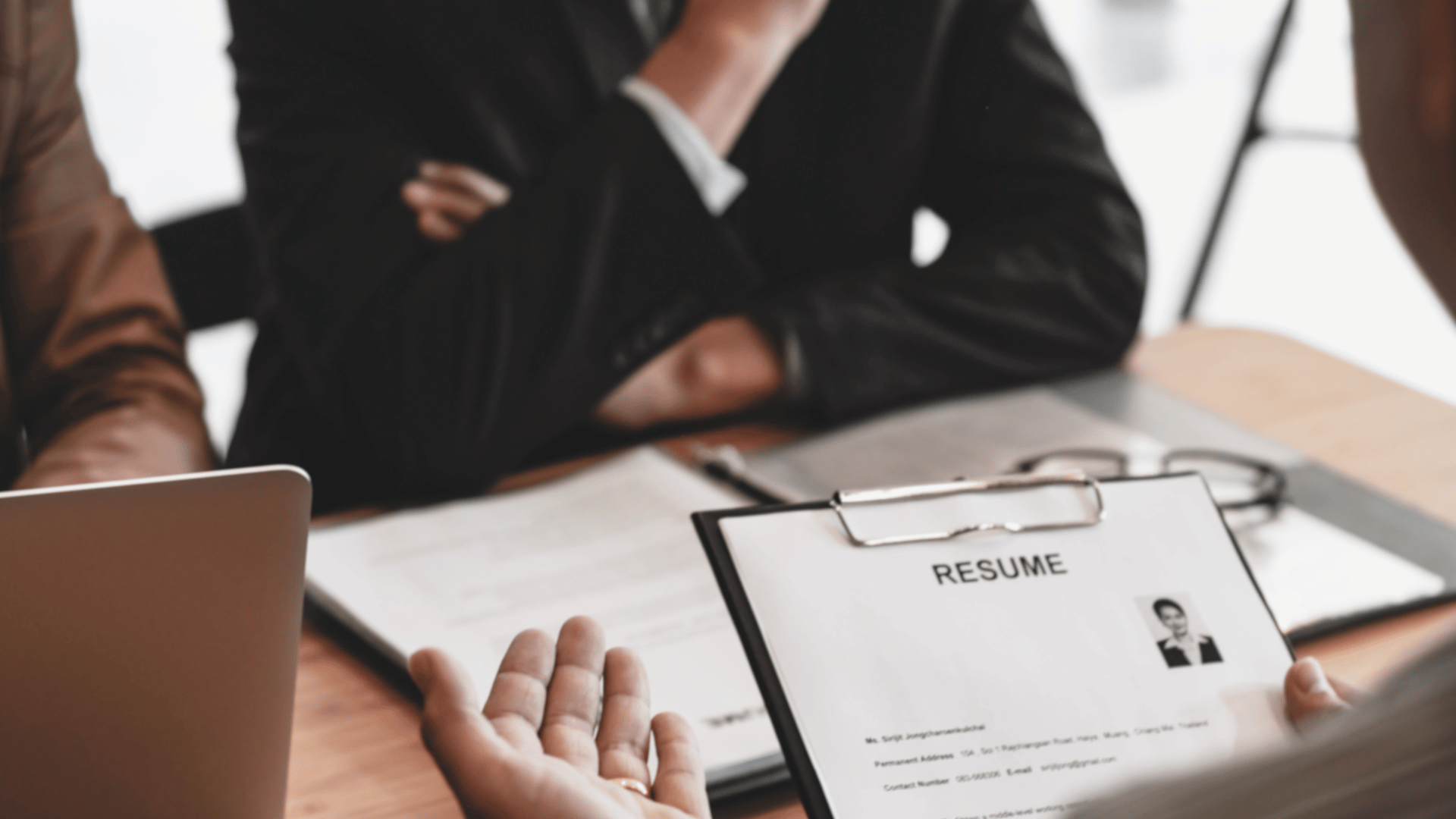 Interviewer reading a resume during a job interview in an office