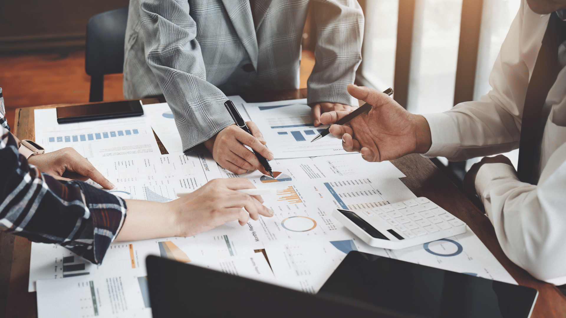 A group of businesspeople discussing marketing strategies and analysing firm's profitability