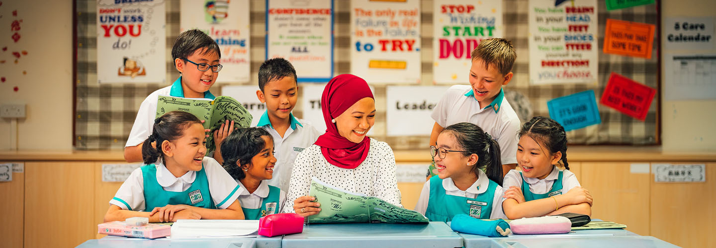 Malay Teacher in Red Tudung Teaching Group of 7 Primary School Students in Uniform